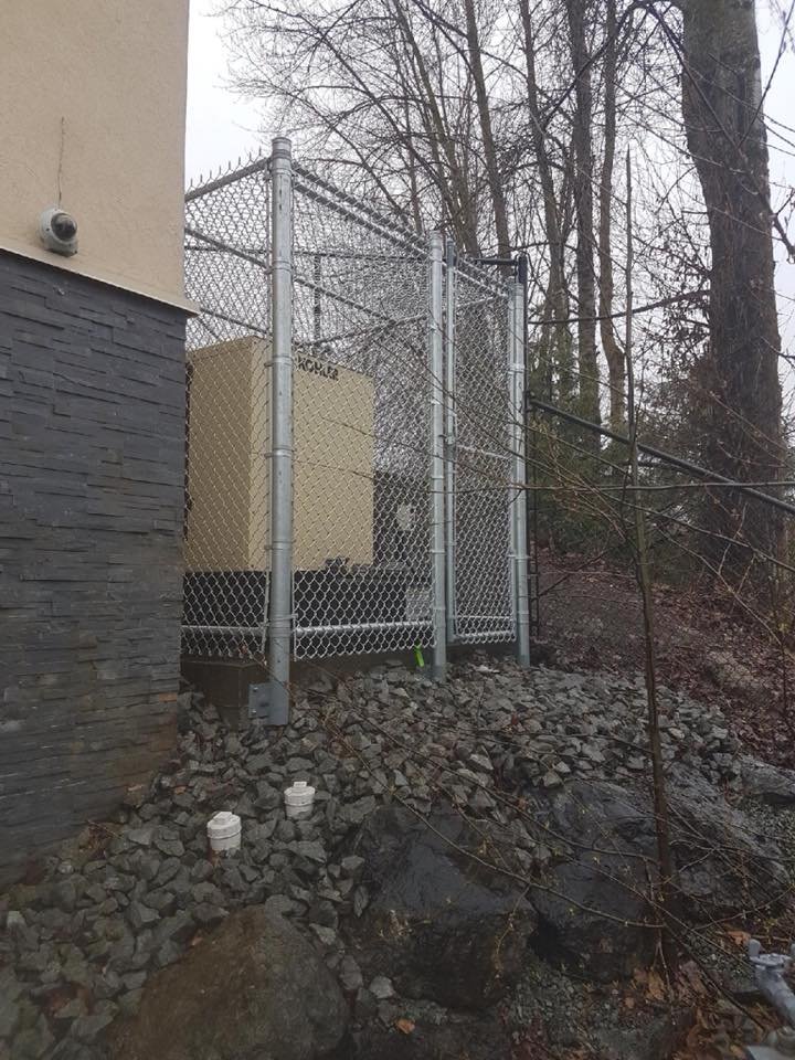 8-foot galvanized chain link commercial security enclosure with covered top installed in the Fraser Valley