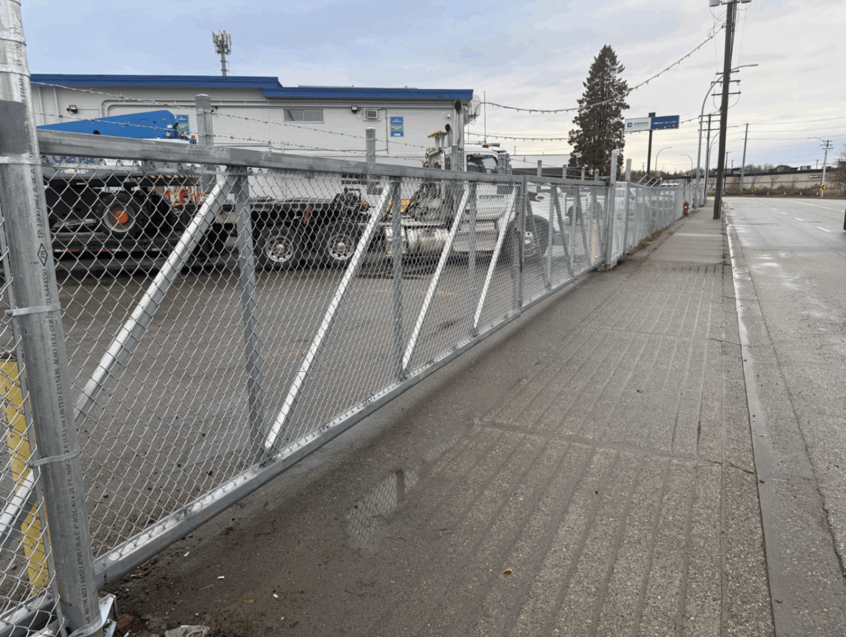 Custom galvanized double cantilever chain link gate installed for Cooper Rentals in Langley BC — North Vancouver, BC commercial project.
