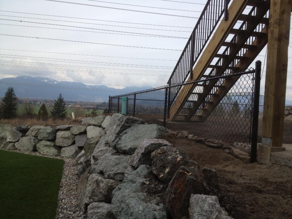 Black vinyl chain link fence along a hillside near Harrison Hot Springs BC