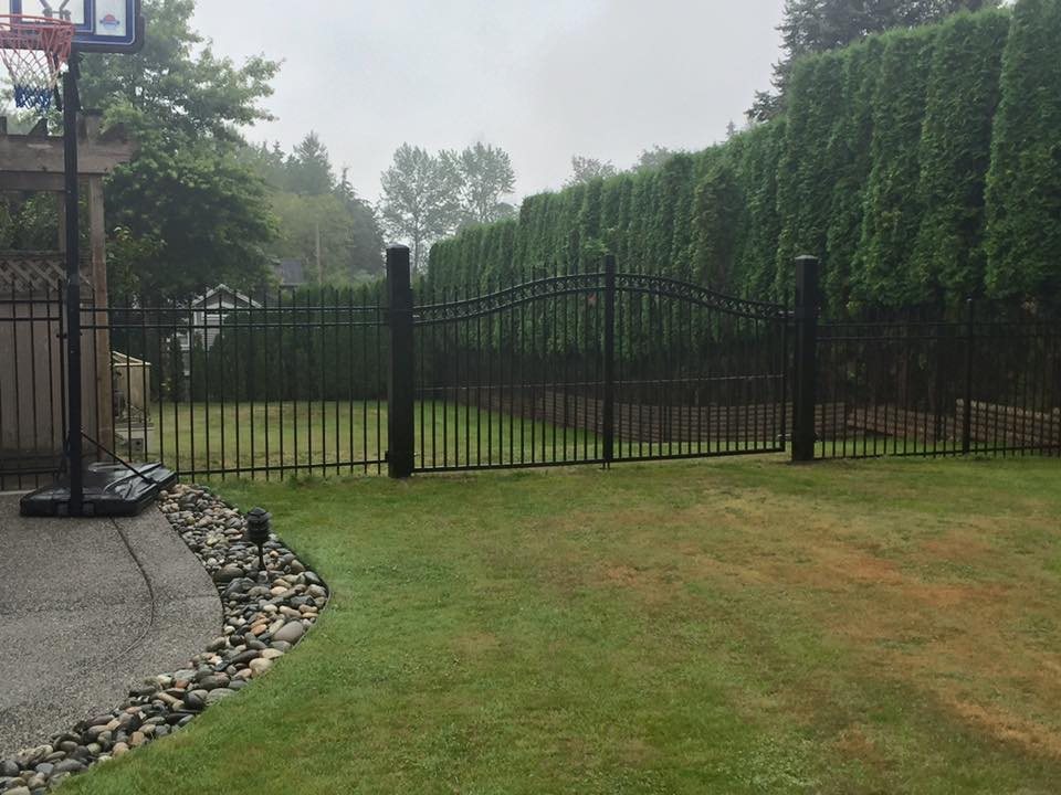 Ornamental gate beside a lawn and hedge — photograph supplied by LS Fencing & Metal Work