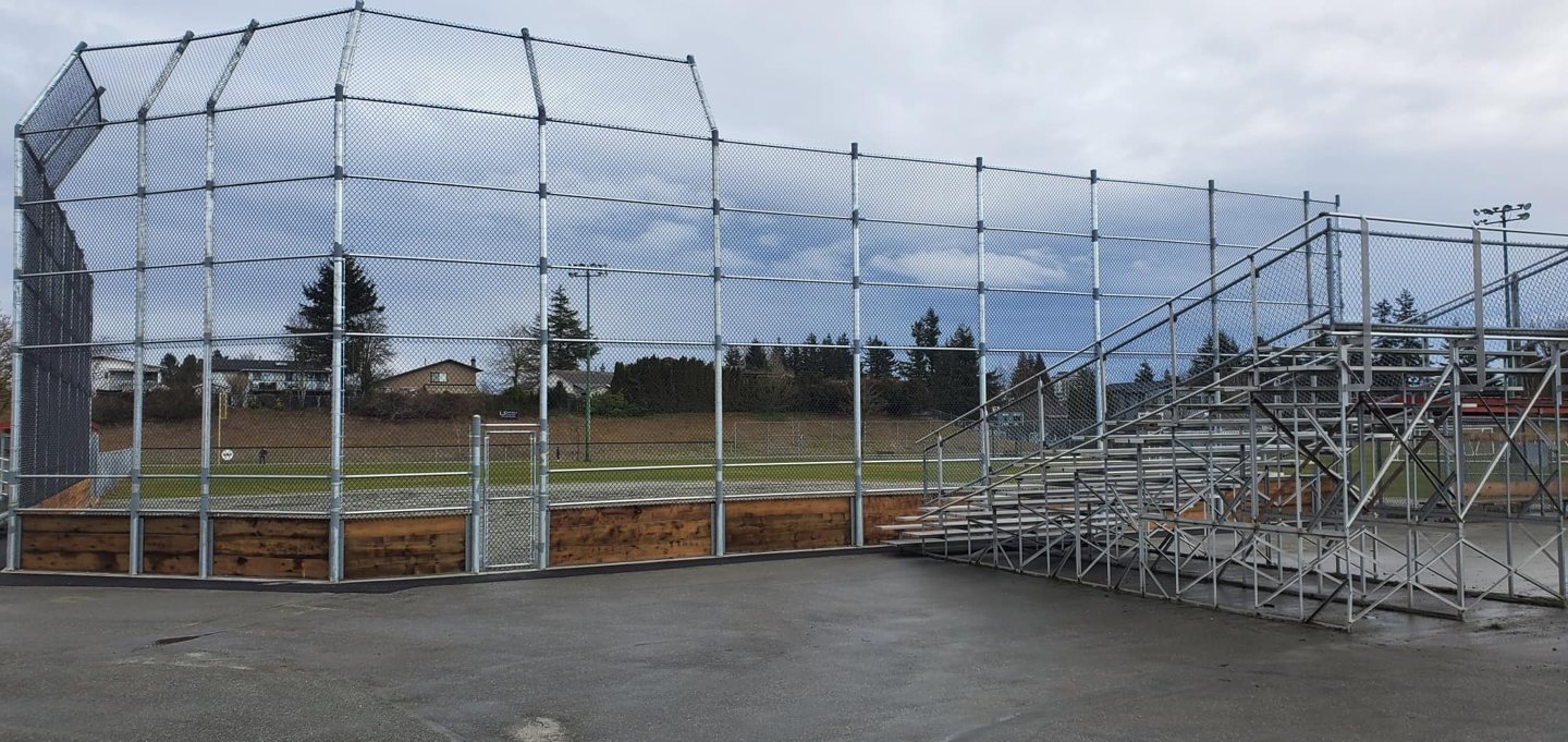 Baseball backstop with overhead chain-link protection — photograph supplied by LS Fencing & Metal Work
