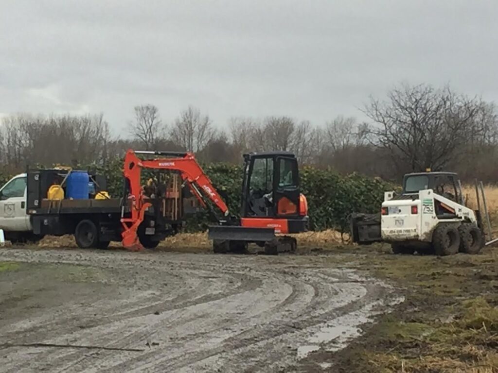 Bobcat loading dump trailer with dirt